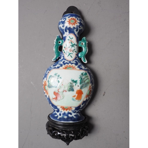 116 - A Chinese famille vert wall pocket with flower and bird decoration, and hardwood stand, 5 3/4