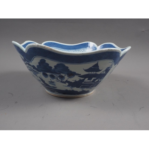 121 - A Chinese blue and white shaped rim bowl with panelled landscape decoration, 9 1/2