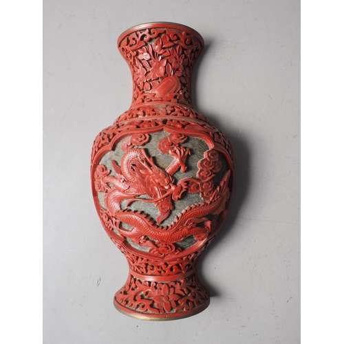 135 - A Chinese cinnabar lacquered wall pocket, formed as a vase with dragon and flower decoration, 9