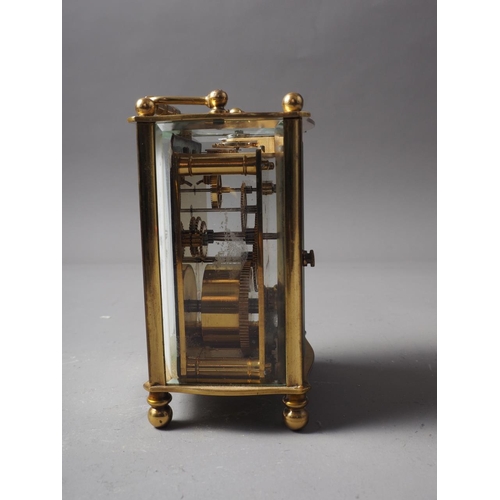 141 - A brass cased carriage clock with travelling case, clock 4 1/2