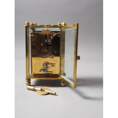 141 - A brass cased carriage clock with travelling case, clock 4 1/2