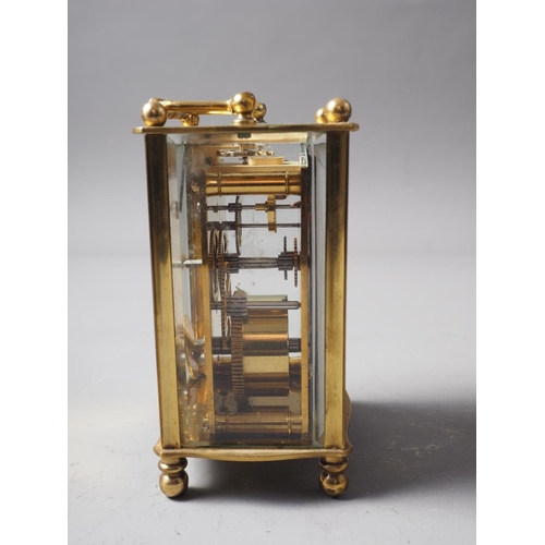 141 - A brass cased carriage clock with travelling case, clock 4 1/2