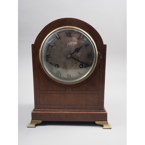 158 - A mahogany arch topped mantel clock with silvered dial and Roman numerals, 8 1/2