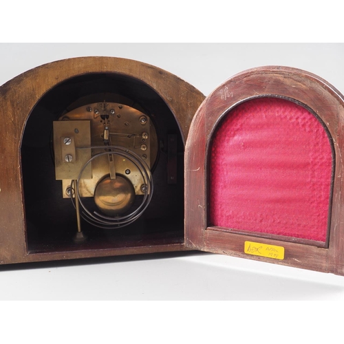 158 - A mahogany arch topped mantel clock with silvered dial and Roman numerals, 8 1/2