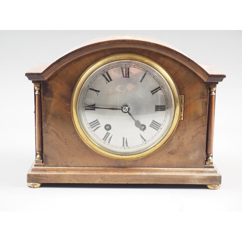 158 - A mahogany arch topped mantel clock with silvered dial and Roman numerals, 8 1/2