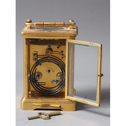 166 - A Goldsmiths and Silversmiths brass cased carriage clock with white enamel dial and Roman numerals, ... 