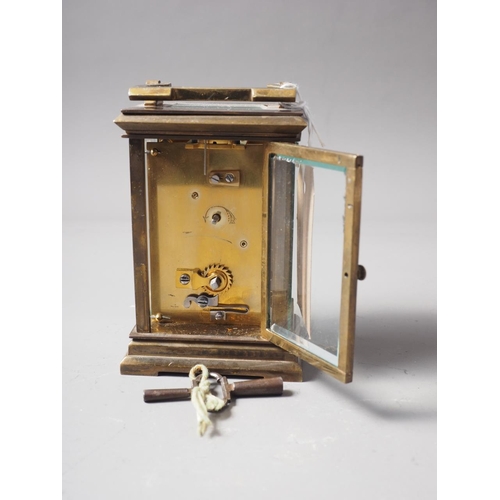 168 - A brass cased carriage clock with white enamel dial and Roman numerals