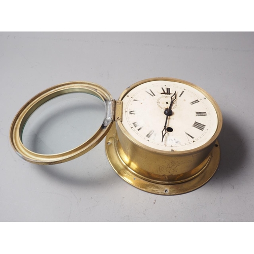 169 - An Armstrong of Manchester brass cased bulkhead clock with Roman numerals and enamelled dial, 7 1/2