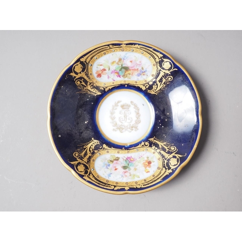 19 - A Sevres style cabinet cup with cherub and monogram decoration on a brown ground, a similar saucer w... 