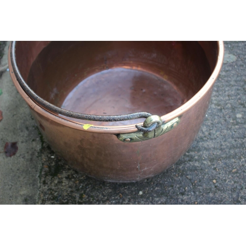 197 - A copper cauldron with wrought iron handle, 24