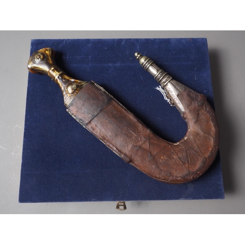 235 - An Islamic Hijaz Jambiya with white metal and leather sheath inset semi-precious stones, in case