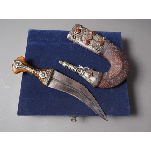 235 - An Islamic Hijaz Jambiya with white metal and leather sheath inset semi-precious stones, in case