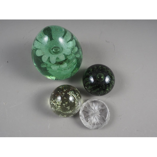 38 - A 19th century glass door stop, two bubble glass paperweights and a cut glass paperweight