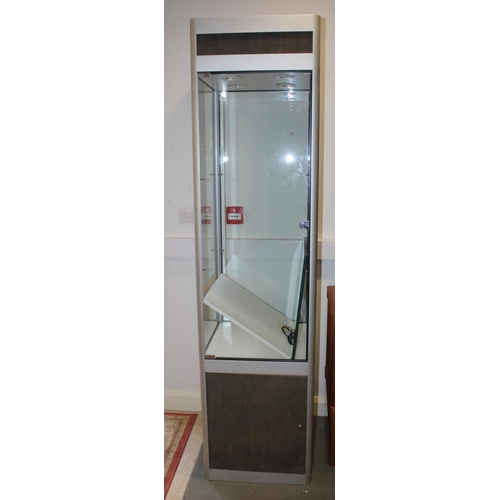 608 - A contemporary aluminium glass display cabinet fitted two glass shelves over cupboard enclosed one d... 