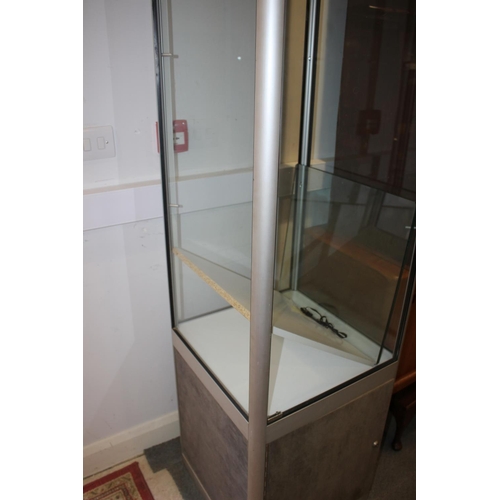 608 - A contemporary aluminium glass display cabinet fitted two glass shelves over cupboard enclosed one d... 