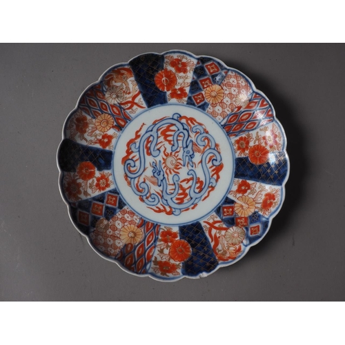 85 - A Japanese blue and white dish with sectioned floral bordered decoration and six-character mark to b... 