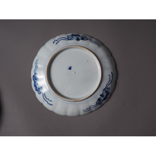 85 - A Japanese blue and white dish with sectioned floral bordered decoration and six-character mark to b... 