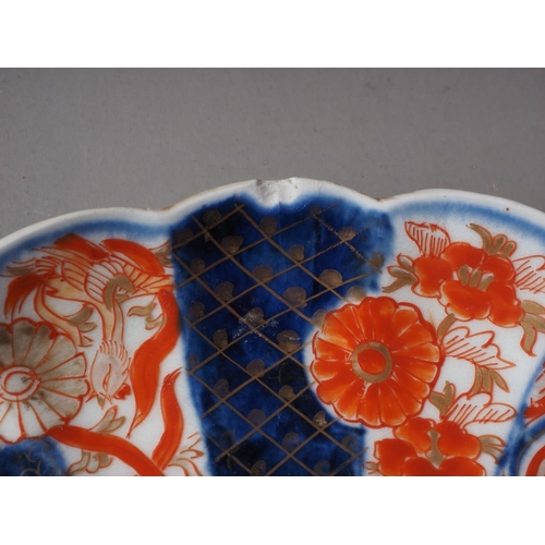 85 - A Japanese blue and white dish with sectioned floral bordered decoration and six-character mark to b... 