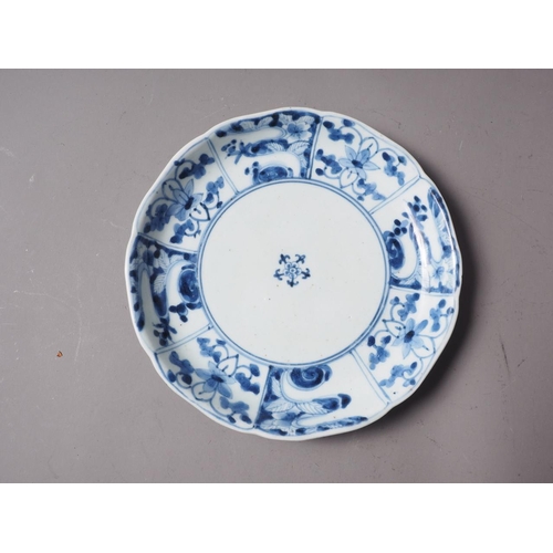 85 - A Japanese blue and white dish with sectioned floral bordered decoration and six-character mark to b... 