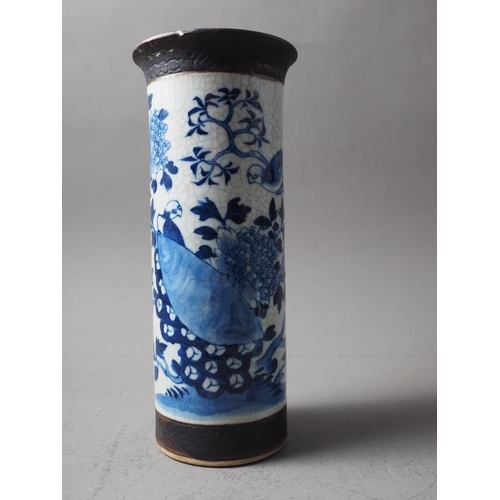 93 - A Chinese blue, white and unglazed cylindrical flared rim crackle glaze vase with bird and tree deco... 