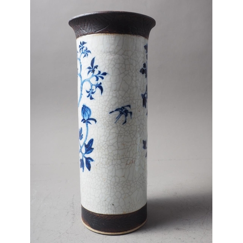 93 - A Chinese blue, white and unglazed cylindrical flared rim crackle glaze vase with bird and tree deco... 