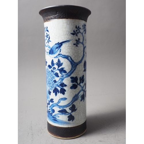 93 - A Chinese blue, white and unglazed cylindrical flared rim crackle glaze vase with bird and tree deco... 