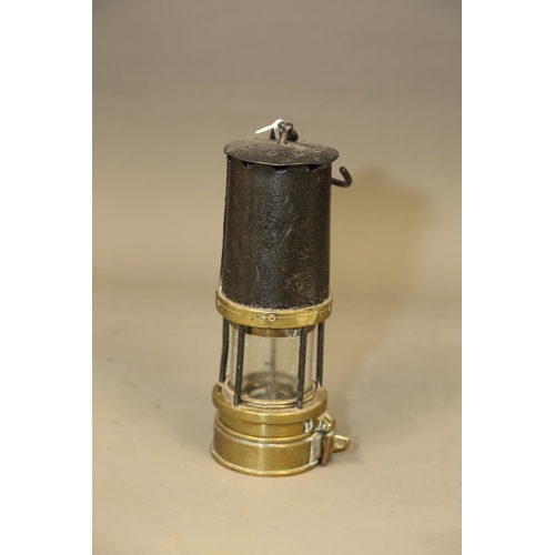 182 - A miners early 20th century Richard Johnson, Clapham & Morris brass and base metal safety lamp, ... 