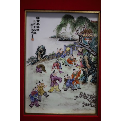 134 - A pair of Chinese porcelain panels, decorated figures playing in a garden and verse, 10