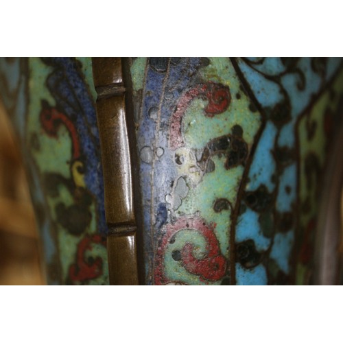 136 - An antique Chinese cloisonne gu vase with all-over scroll and mask design, 14