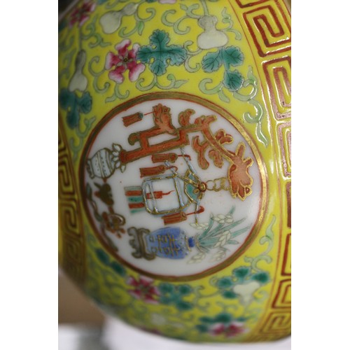 109 - A Chinese famille rose bowl, decorated four circular panels with precious objects and flowers on a y... 