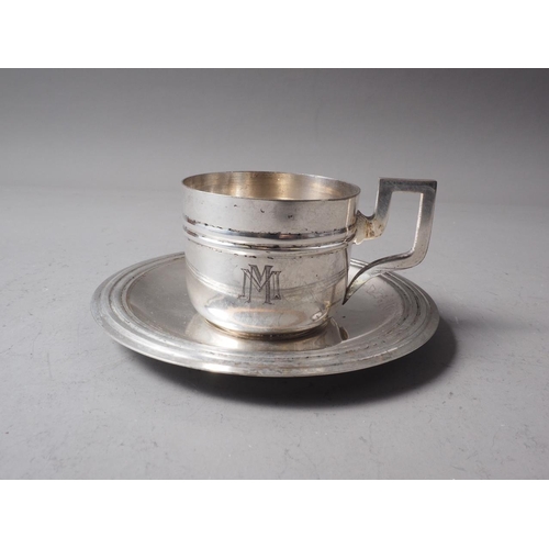 320 - A white metal coffee cup and saucer with monogram, two silver mounted dressing table jars and a Fren... 