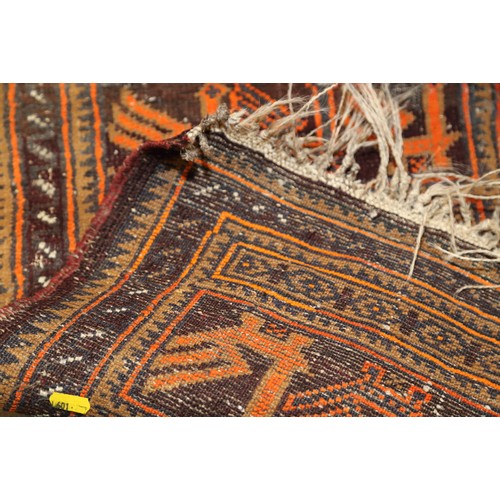 574 - A tribal woven mat with bird design, in shades of natural and orange on a brown ground, 25 1/2