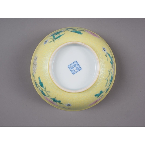 102 - A Chinese porcelain bowl, decorated with sprays on a yellow ground, 6 1/4