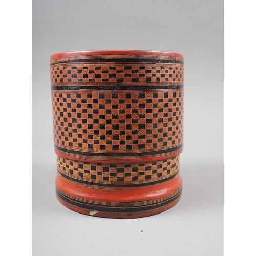 103 - An Oriental red and black lacquered cylindrical box and cover with lift-out trays, 4 1/2