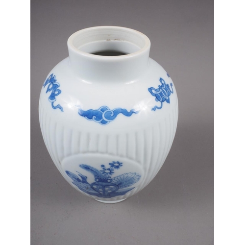 107 - A Chinese export blue and white fluted jar, decorated panels with precious objects, 6