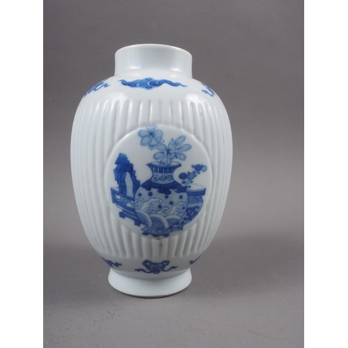 107 - A Chinese export blue and white fluted jar, decorated panels with precious objects, 6