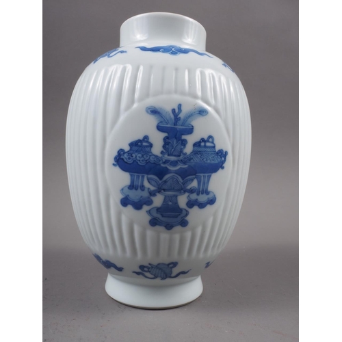 107 - A Chinese export blue and white fluted jar, decorated panels with precious objects, 6