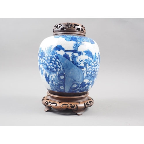 111 - A Chinese blue and white crackle glazed ginger jar with floral decoration, and associated carved har... 