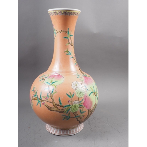 115 - A Chinese bulbous vase with peach and flower decoration on an orange ground and six-character mark t... 