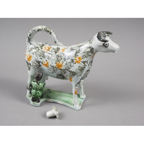 13 - An early 19th century Yorkshire pearlware sponge decorated cow creamer and milkmaid, 5 1/2