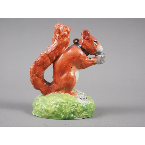 14 - An early 19th century red squirrel with a nut, 3 1/4