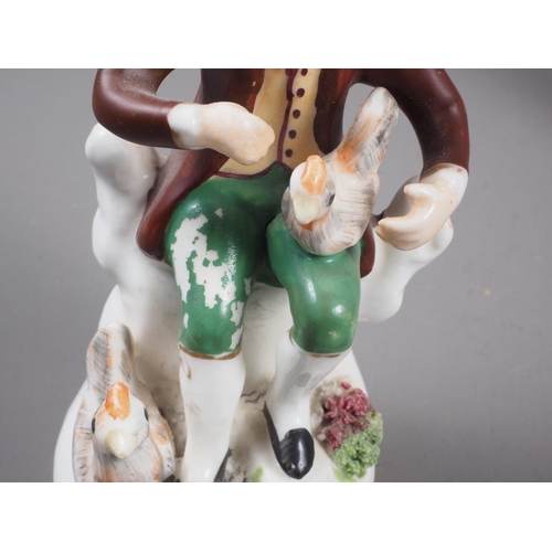 17 - A 19th century Staffordshire bone china figure of a hunter with a rabbit, on rockwork base, 4 1/2