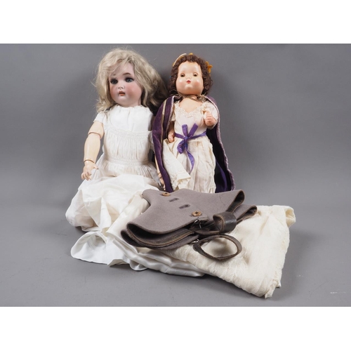 173 - A Halbig K R bisque headed doll, a similar smaller doll, a pair of boot covers and other materials