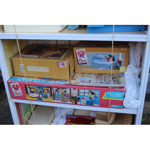 185 - A Sindy three-storey doll's house, two Sindy dolls, a selection of Sindy doll's furniture comprising... 