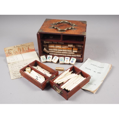 194 - A Mah-jongg set with bone and bamboo counters, in a hardwood and brass mounted box