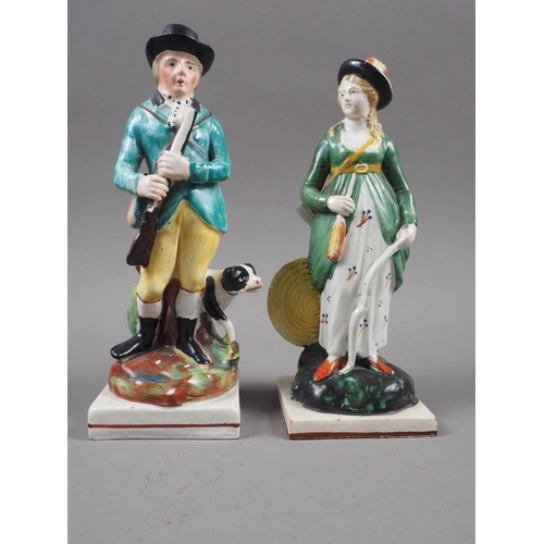 20 - An early 19th century Staffordshire figure of a huntsman with gun dog, 7 1/4