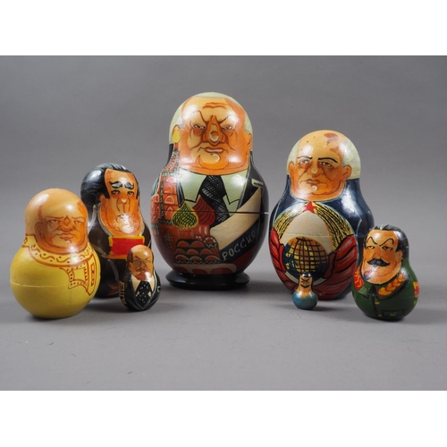 214 - A Russian seven-piece hand painted nesting doll set, decorated Czar Nicholas and six Russian Communi... 