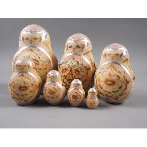 214 - A Russian seven-piece hand painted nesting doll set, decorated Czar Nicholas and six Russian Communi... 