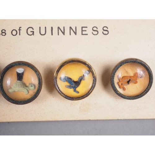 242 - A set of six Guinness reverse painted buttons, on original card