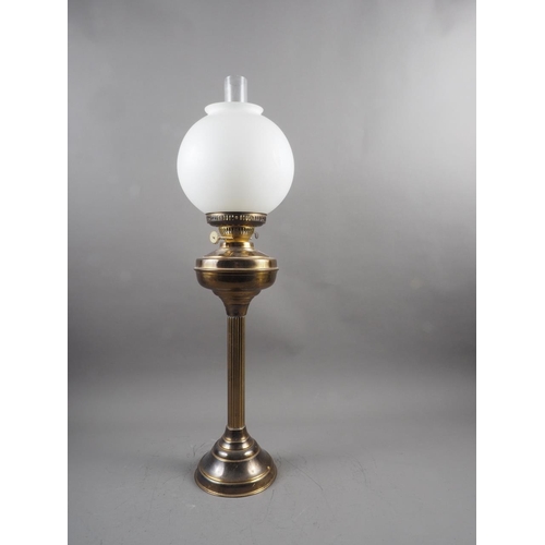 268 - A brass oil lamp with frosted globe shade